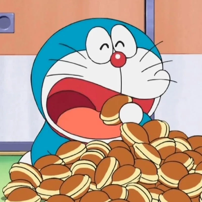 Thưởng thức hình nền Doraemon ăn bánh rán ngọt ngào